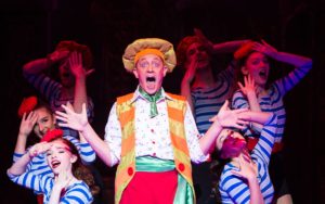 Beauty and The Beast – Jon Monie as Louis La Plonk with the Ensemble – Photo credit Freia Turland